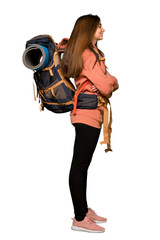 Full-length shot of Hiker girl in lateral position on isolated white background
