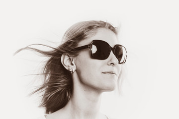 face of a pretty girl blonde in sunglasses close-up on a white background
