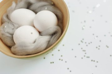 Easter. Easter eggs. Bokeh. Silver. Bowl with eggs