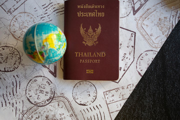 Thailand passport Put on the table planning her next trip around the world,booking travel with digital technology app via laptop, search website service hotel Happy Holiday Trip