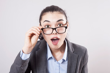 Surprise astonished woman. Closeup portrait woman looking surprised in full disbelief wide open mouth isolated grey wall background