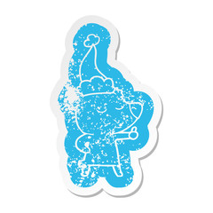 happy cartoon distressed sticker of a bear giving thumbs up wearing santa hat