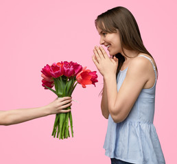 Crop boy giving bouquet to woman 