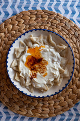 Manti, traditional Turkish food. Turkish Ravioli. Served with yoghurt and butter sauce.