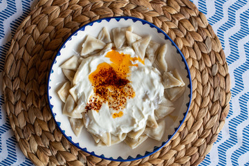 Manti, traditional Turkish food. Turkish Ravioli. Served with yoghurt and butter sauce.