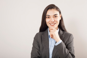 Young businesswoman on gray background