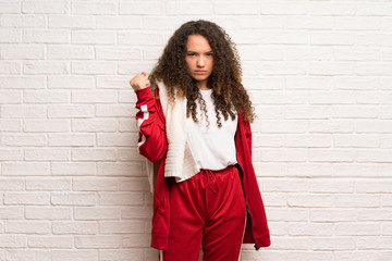 Teenager sport girl with curly hair with angry gesture