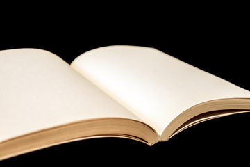 Old open blank book on black background