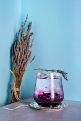 Soda water drink with blueberries. Cold refreshing beverage on bar counter.