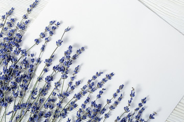 Branches of lavender on wood and paper for your text. Cosmetic moskup.