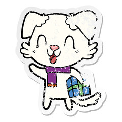 distressed sticker of a laughing cartoon dog with christmas present