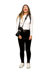 Full body of Young photographer woman shouting to the front with mouth wide open