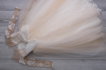 Beautiful dress with lace for small princess on wooden background.