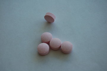 pink pills on white background