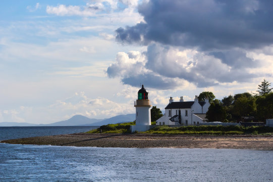 Corran lighthouse watches Loch Linnhe under dramatic sky, near Fort William, in Scottish Highlands