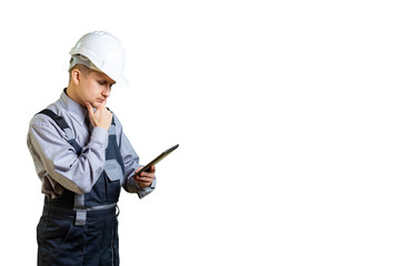 Engineer builder in helmet thinking and looking into the tablet. There is an interesting idea for construction or repair. isolated