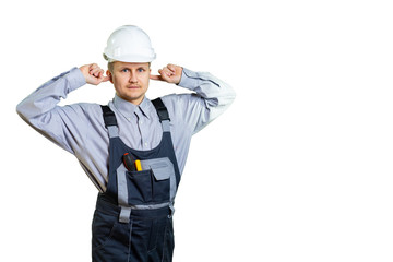 Portrait of young architect covering ears like not hearing and smiling on isolated background