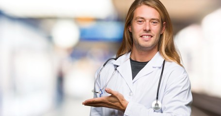 Doctor man presenting an idea while looking smiling towards in a hospital