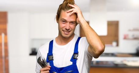 Fototapeta premium Workman with an expression of frustration and not understanding in a house