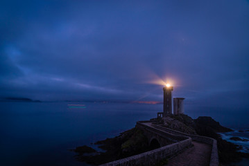 Petit minou lighthouse at night with light beam shining