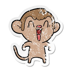 distressed sticker of a cartoon laughing monkey