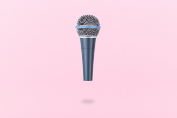 levitating microphone on a pink background, the image in the air