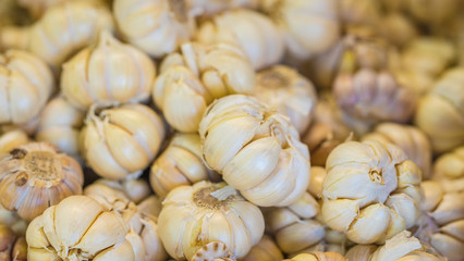 A stack of garlic cloves for sale at market