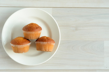Three muffins on a white plate.Sweet dessert.