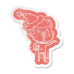 cartoon distressed sticker of a excited man wearing santa hat