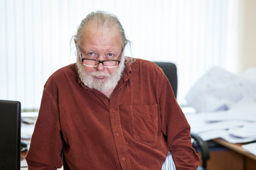 Scientist occupation senior man with white beard and eyeglasses, looking at camera, portrait