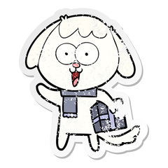 distressed sticker of a cute cartoon dog with christmas present