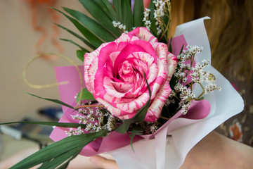 Girl holding a rose, arranging a bouquet, working in a flower shop, gift for 8 march, mother's day,  women's day or St. Valentine, birthday present, wedding day concept