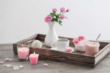 roses in vase and cup of coffee on tray
