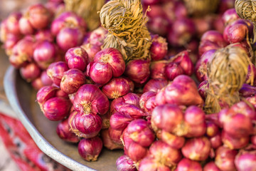 A stack of red onion for sale at market