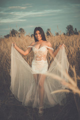 Portrait of beautiful asian woman wear white dress in the field on sunset,Thailand people