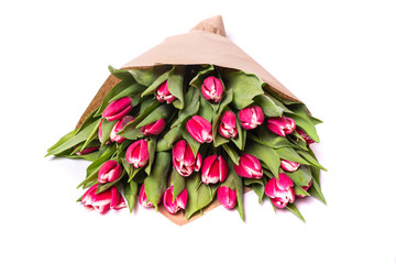 Bouquet of a pink tulips lying isolated on background white Kraft paper