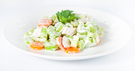 Fresh delicious healthy salad with celery, carrot and meat on white