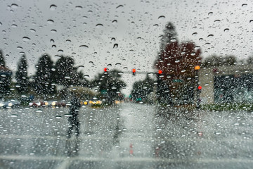 Pedestrian crossing the street on a rainy day, California