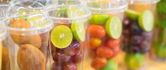 Fresh mix fruit shake cut into small pieces in a disposable glass