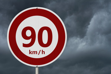 Red and white 90 km speed limit sign