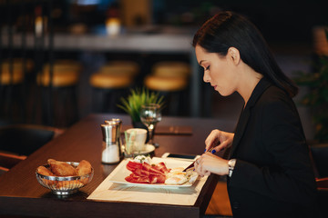 Young business woman on breakfast in a restaurant