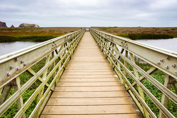 Wood and metal bridge crossing the Rodeo Lagoon towards Rodeo Beach, Headlands, Golden Gate Recreation Area, Marin County, California
