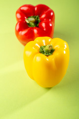yellow and red paprika on green background