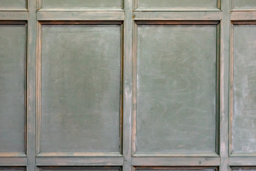 Old medieval wood paneling covering a wall in a historical country house with a diamond pattern marble floor, background image with nobody. Wall wood background