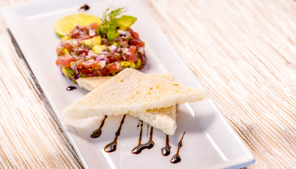Fresh Tuna Tartare on a white plate with toast, Fine dining set