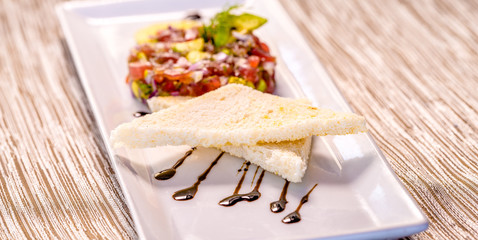 Fresh Tuna Tartare on a white plate with toast, Fine dining set