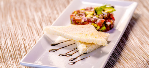 Fresh Tuna Tartare on a white plate with toast, Fine dining set