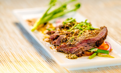 Sliced beef on a white plate, fine dining set