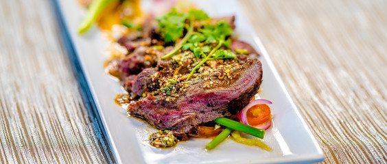 Sliced beef on a white plate, fine dining set
