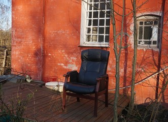 Fototapeta na wymiar Chair in front of building, Christiania, Copenhagen